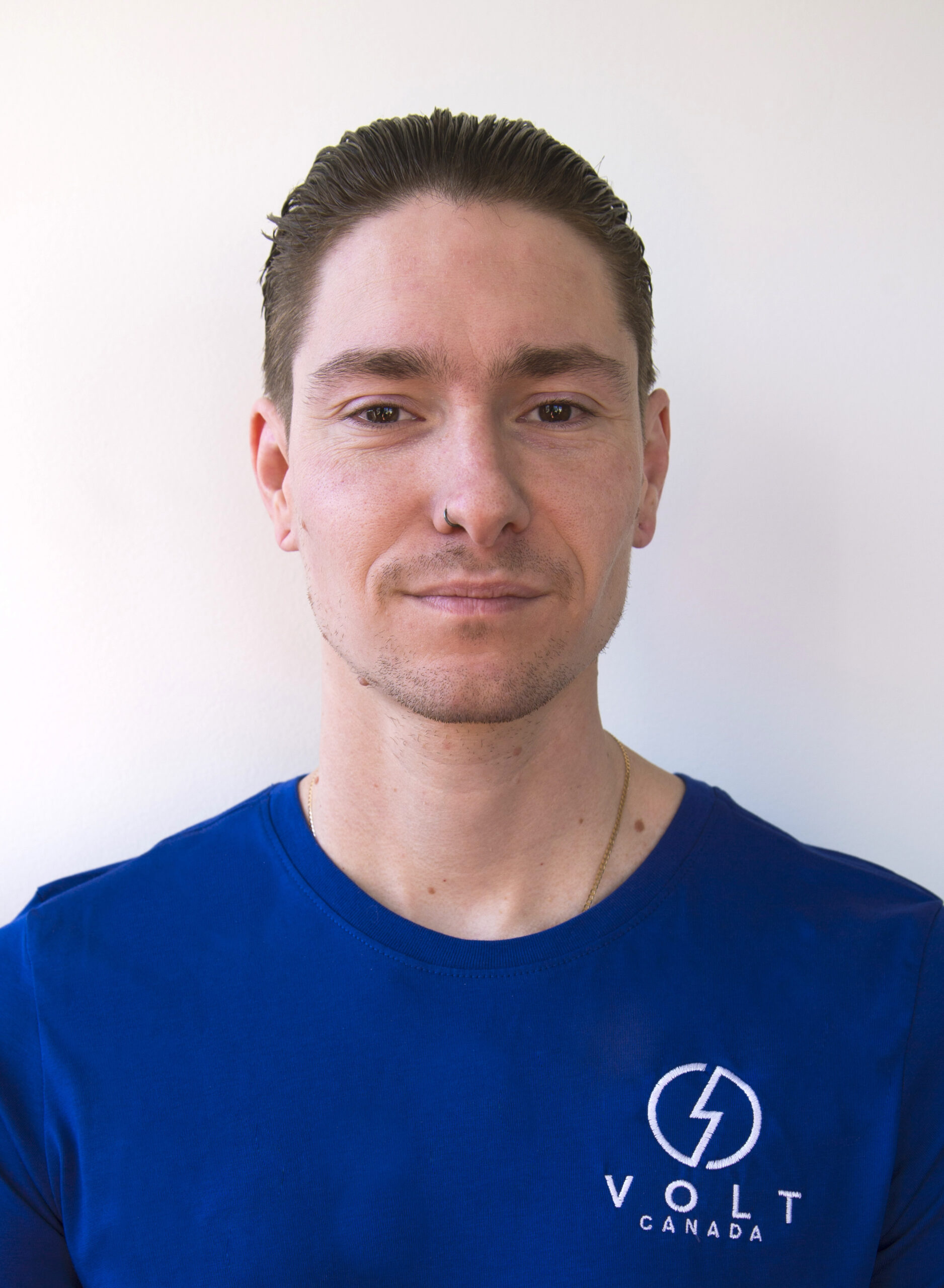 Headshot of Terrance Callaghan wearing a blue shirt with the Volt logo